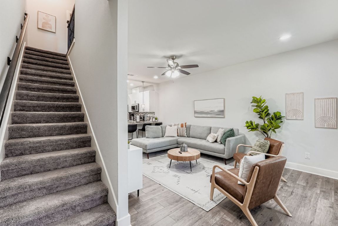 18803 Hogan Circle, Unit 14 Point Venture, TX 78645 - Photo 8 of 40 a living room with furniture and stairs