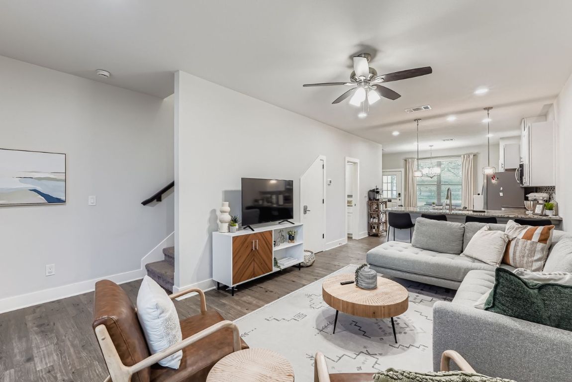 18803 Hogan Circle, Unit 14 Point Venture, TX 78645 - Photo 38 of 40 a living room with furniture a ceiling fan and a flat screen tv