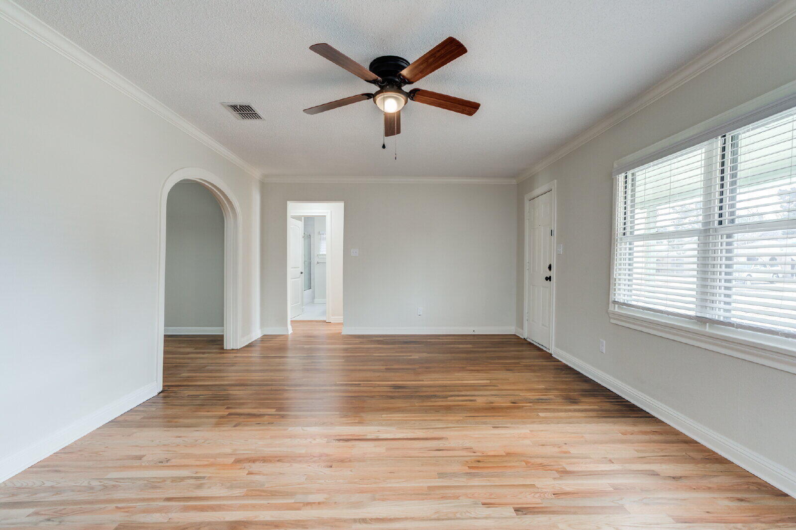 2602 24th Street Lubbock, TX 79410 - Photo 11 of 37 a view of an empty room with wooden floor and a window