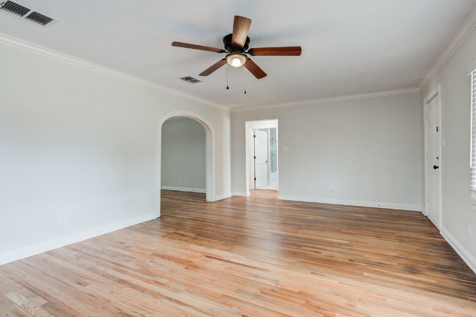 2602 24th Street Lubbock, TX 79410 - Photo 12 of 37 a view of empty room with wooden floor and ceiling fan