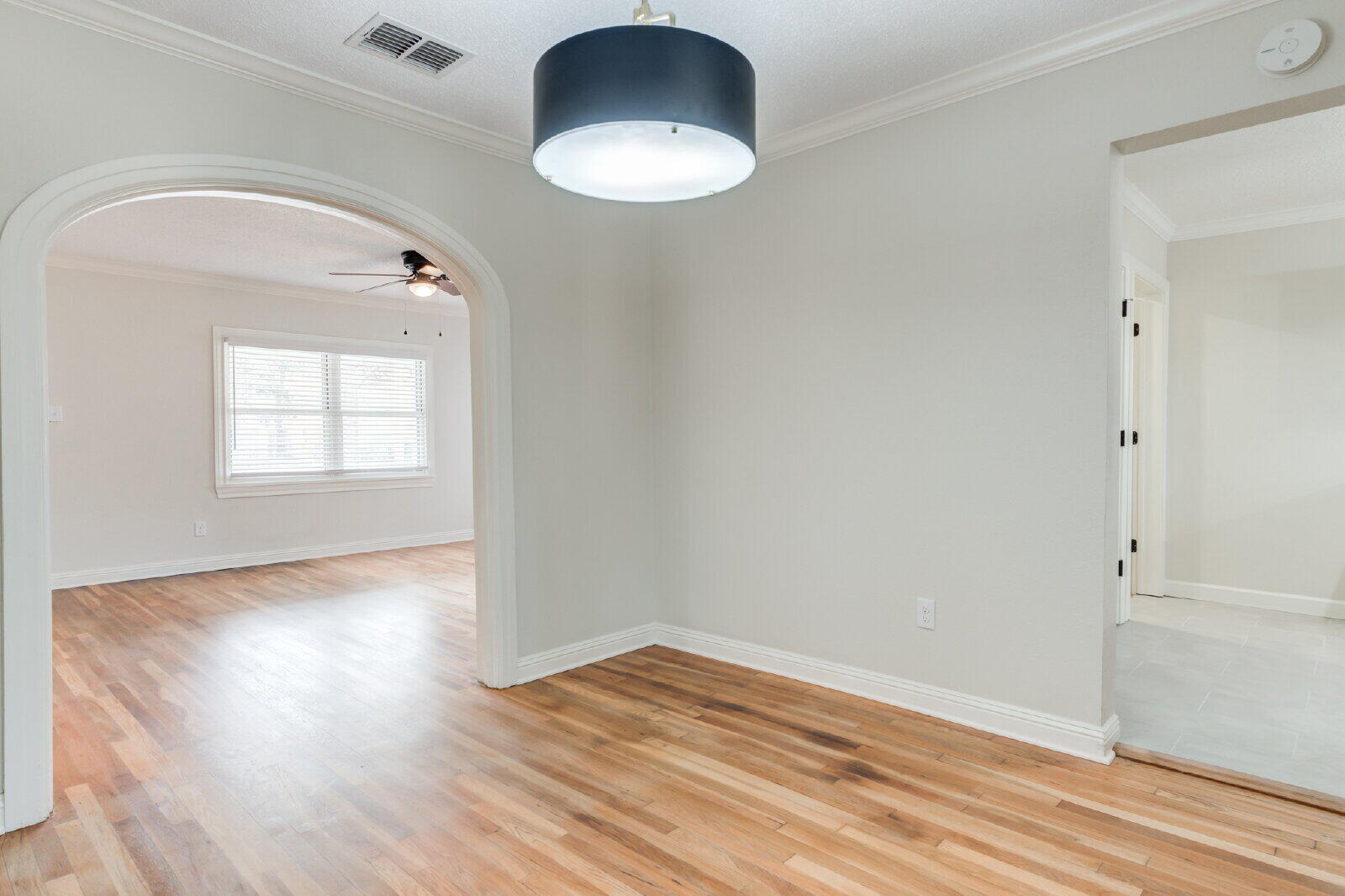 2602 24th Street Lubbock, TX 79410 - Photo 15 of 37 an empty room with wooden floor cabinet and windows