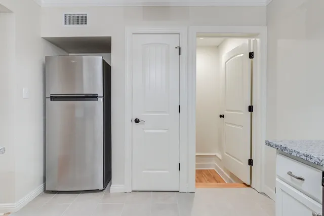 a view of a room with wooden floor and a ceiling fan