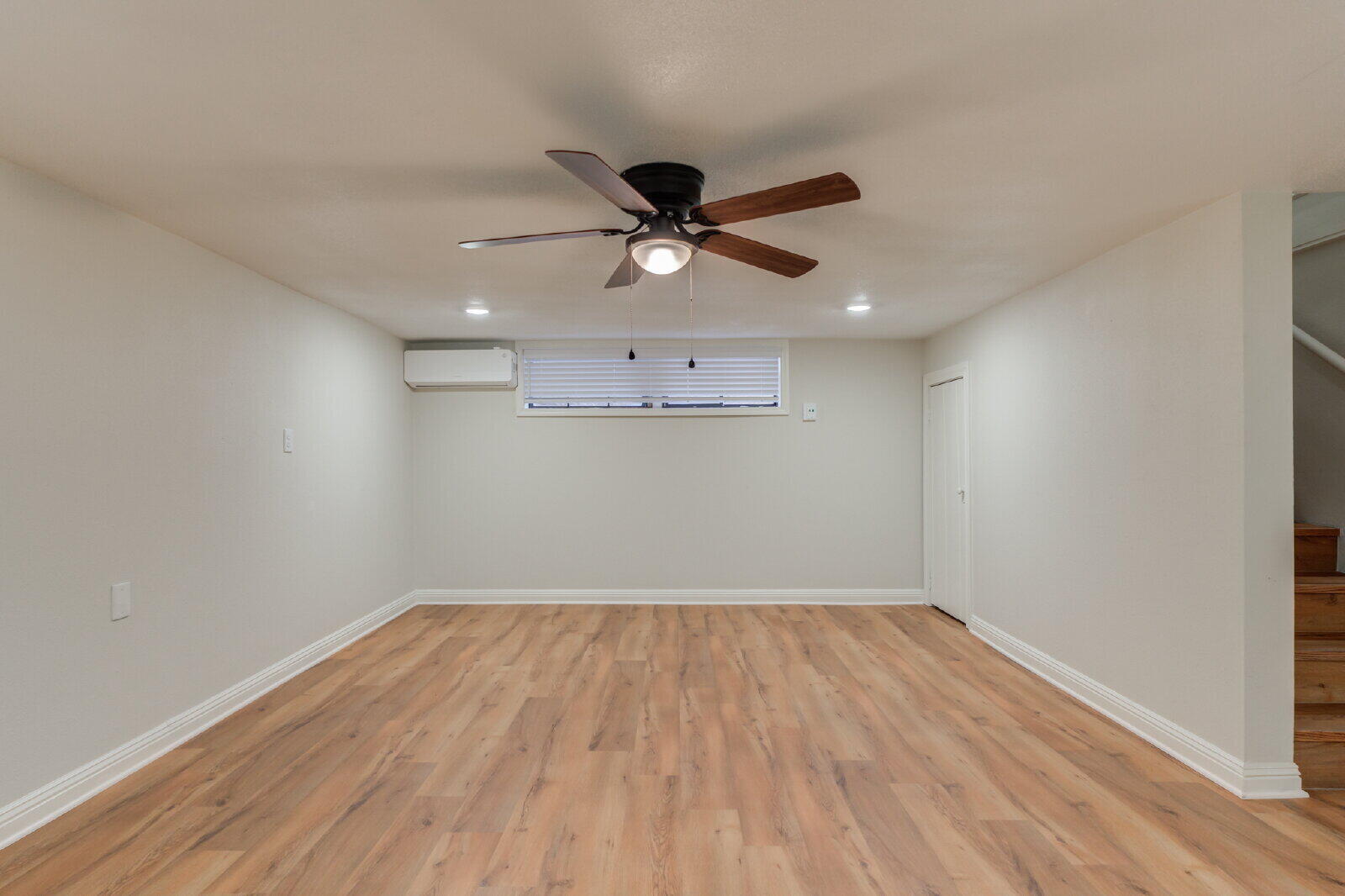 2602 24th Street Lubbock, TX 79410 - Photo 22 of 37 a view of a big room with wooden floor and a ceiling fan