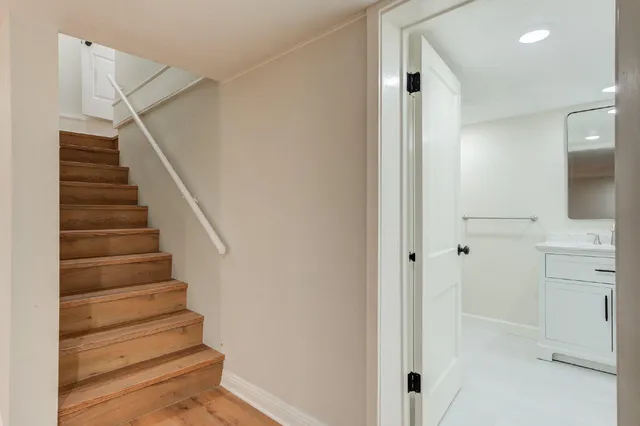 a bathroom with a shower sink and mirror