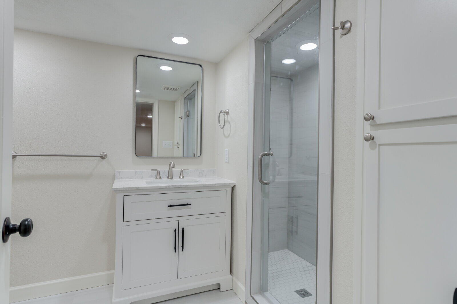 2602 24th Street Lubbock, TX 79410 - Photo 26 of 37 a bathroom with a shower sink and mirror