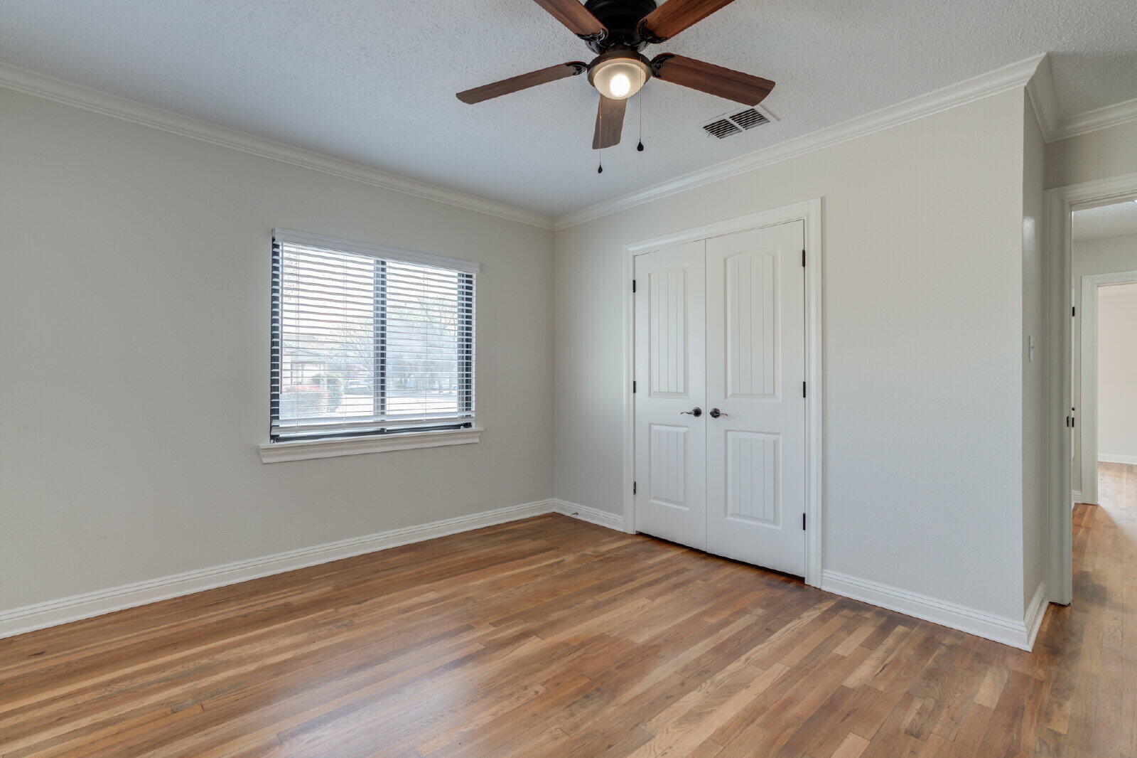2602 24th Street Lubbock, TX 79410 - Photo 35 of 37 a view of an empty room with wooden floor and a window