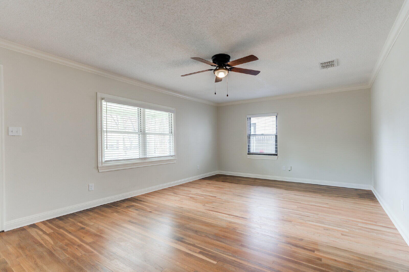 2602 24th Street Lubbock, TX 79410 - Photo 8 of 37 a view of empty room with wooden floor and fan