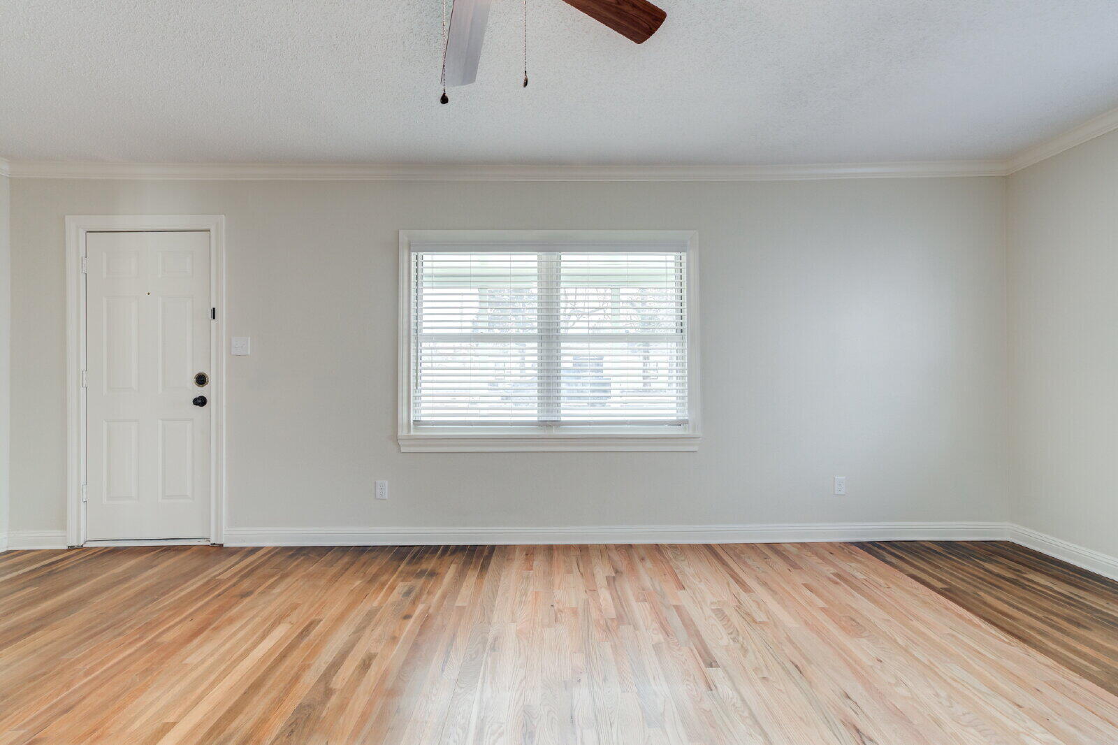 2602 24th Street Lubbock, TX 79410 - Photo 9 of 37 an empty room with wooden floor and windows