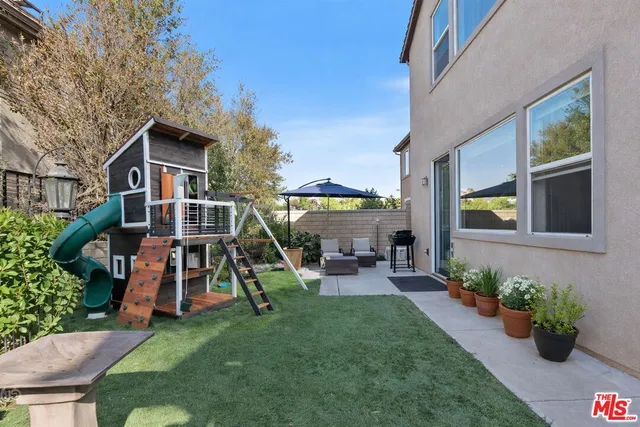 a view of a house with a backyard porch and sitting area