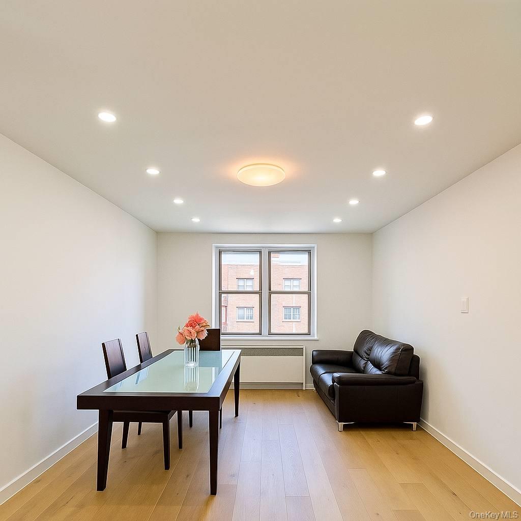 65-70 Booth Street, Unit 5E Queens, NY 11374 - Photo 3 of 5 a living room with furniture and a wooden floor