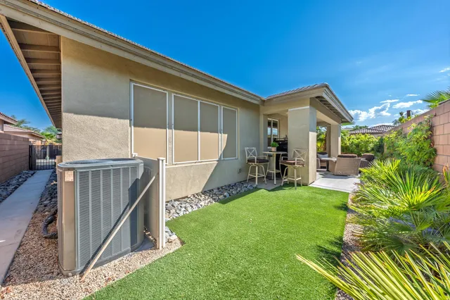 a view of a swimming pool with a dining table and chairs