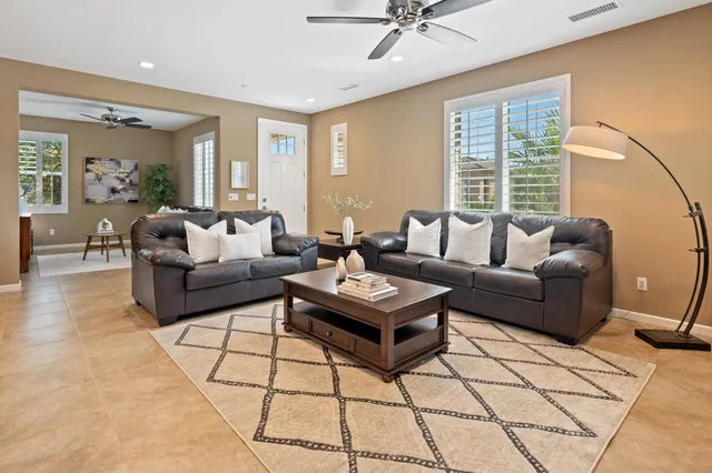 a dining room with furniture a chandelier and window