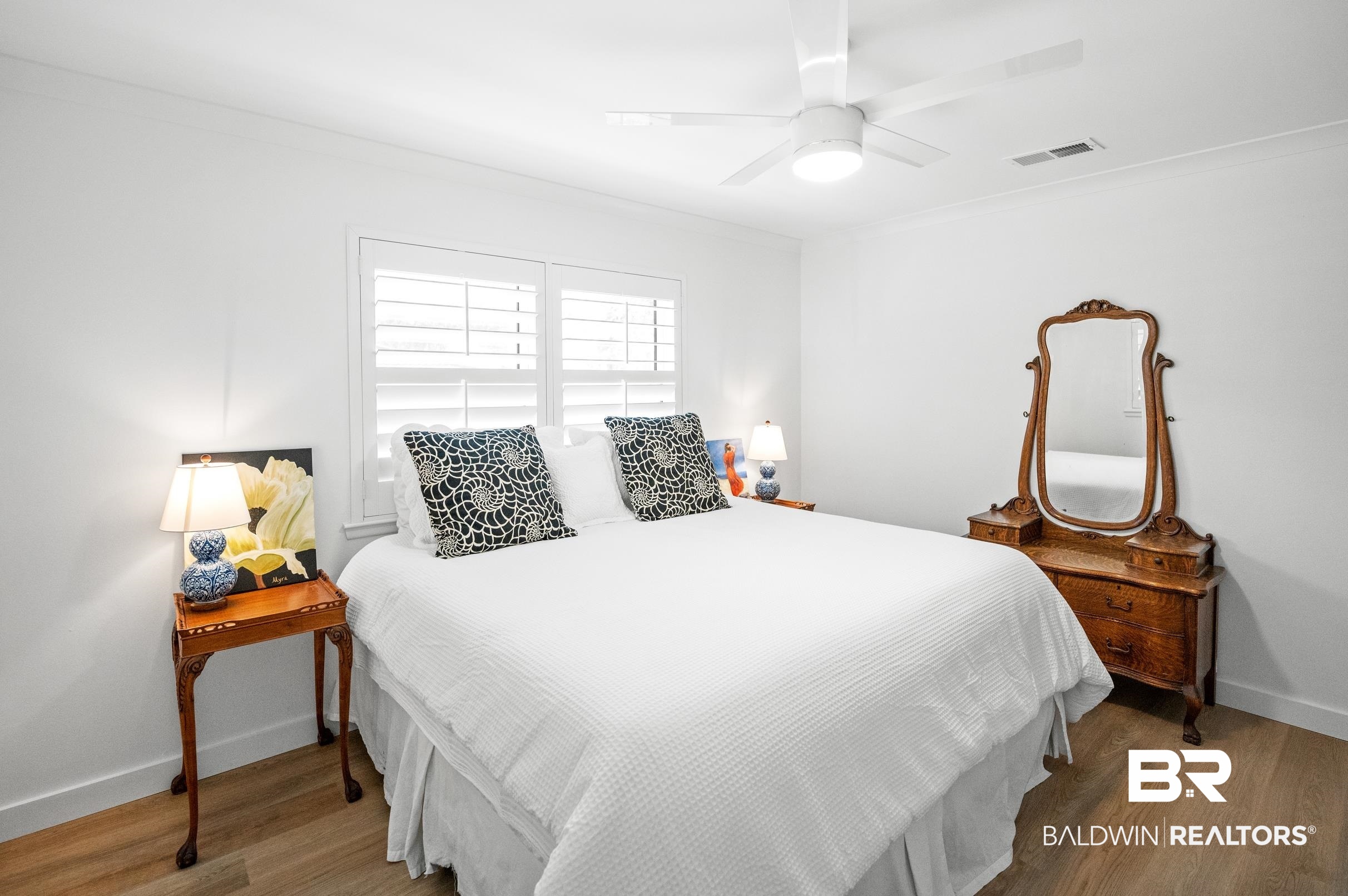 9459 Soldier Creek Road Lillian, AL 36549 - Photo 21 of 54 Bedroom with wood finished floors, a ceiling fan, visible vents, baseboards, and ornamental molding