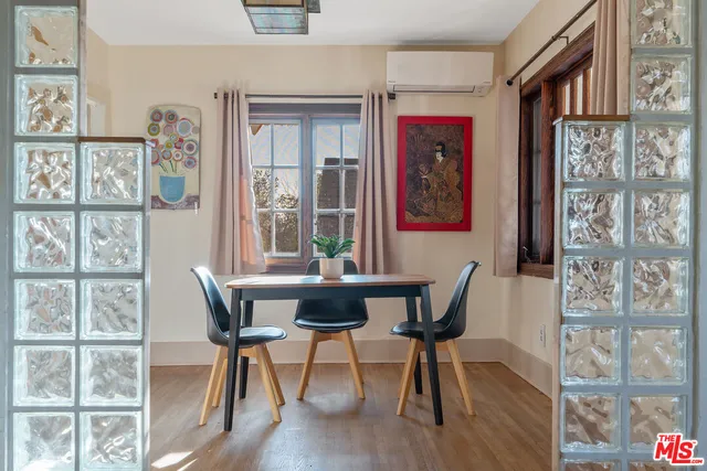 a dining room with furniture and window
