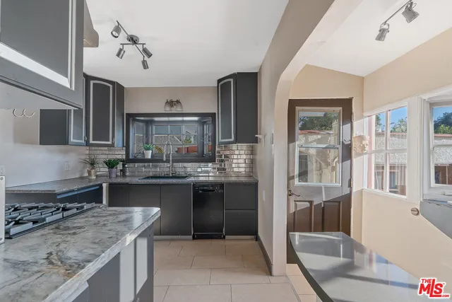 a kitchen with a sink stove and cabinets
