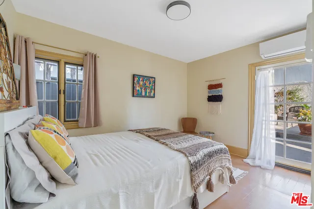 a bedroom with a bed couch and a window