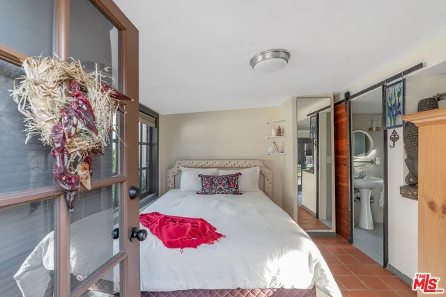 a bedroom with a bed and a dresser