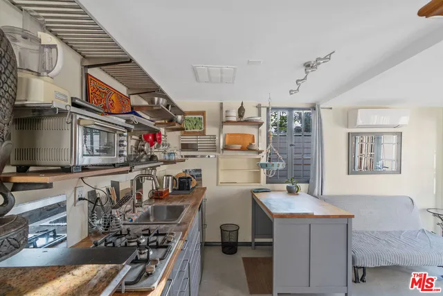 a city room with lots of wooden furniture and windows