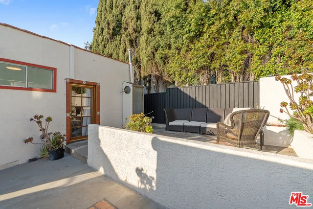 a view of a chairs and table in backyard