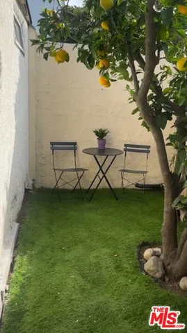 a view of a table and chairs in the yard