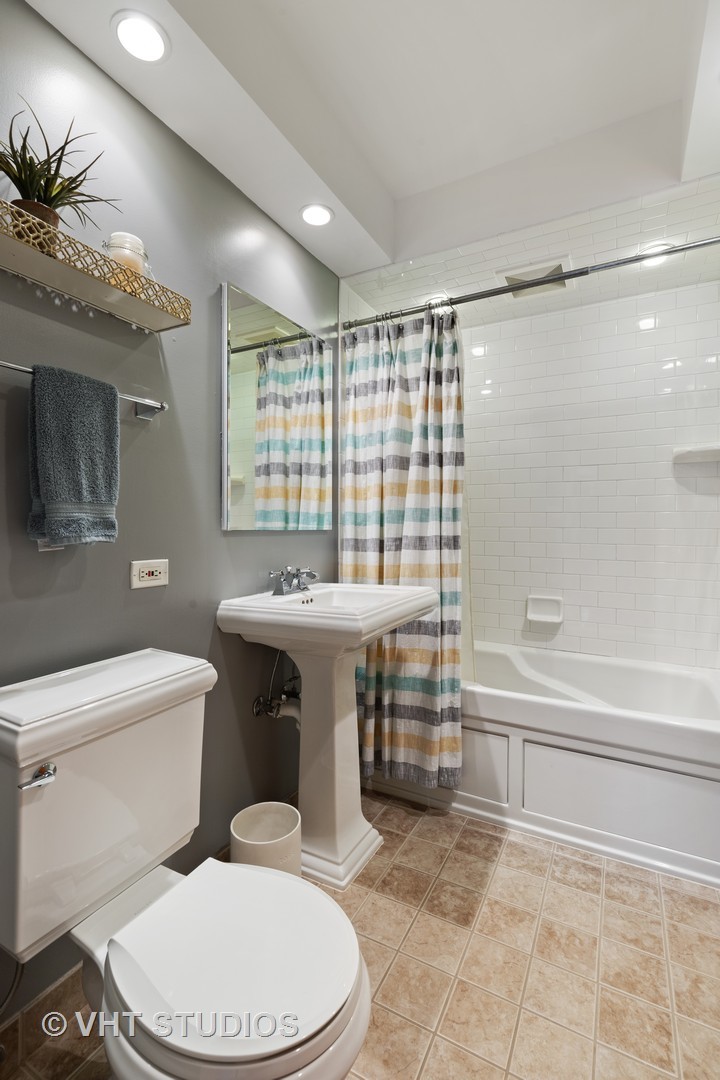 245 East St Charles Road Elmhurst, IL 60126 - Photo 12 of 18 a bathroom with a sink a toilet and shower