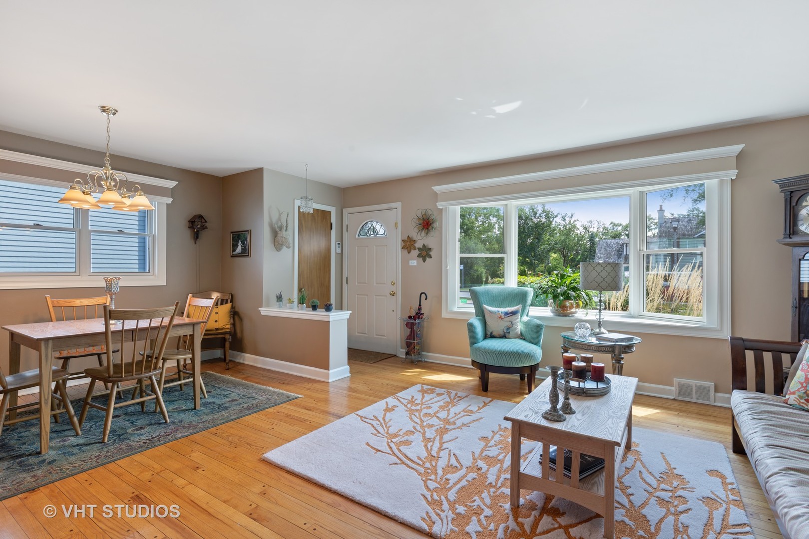 245 East St Charles Road Elmhurst, IL 60126 - Photo 3 of 18 a living room with furniture a rug a lamp and a window