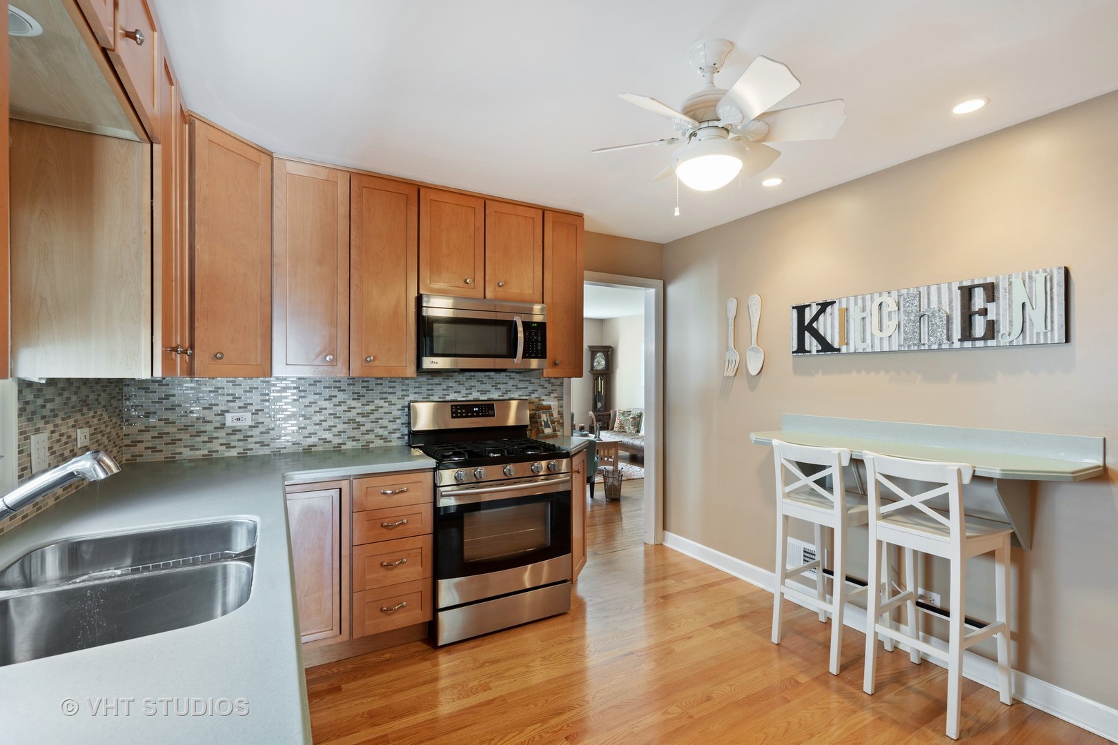 245 East St Charles Road Elmhurst, IL 60126 - Photo 5 of 18 a kitchen with stainless steel appliances granite countertop a stove refrigerator and microwave