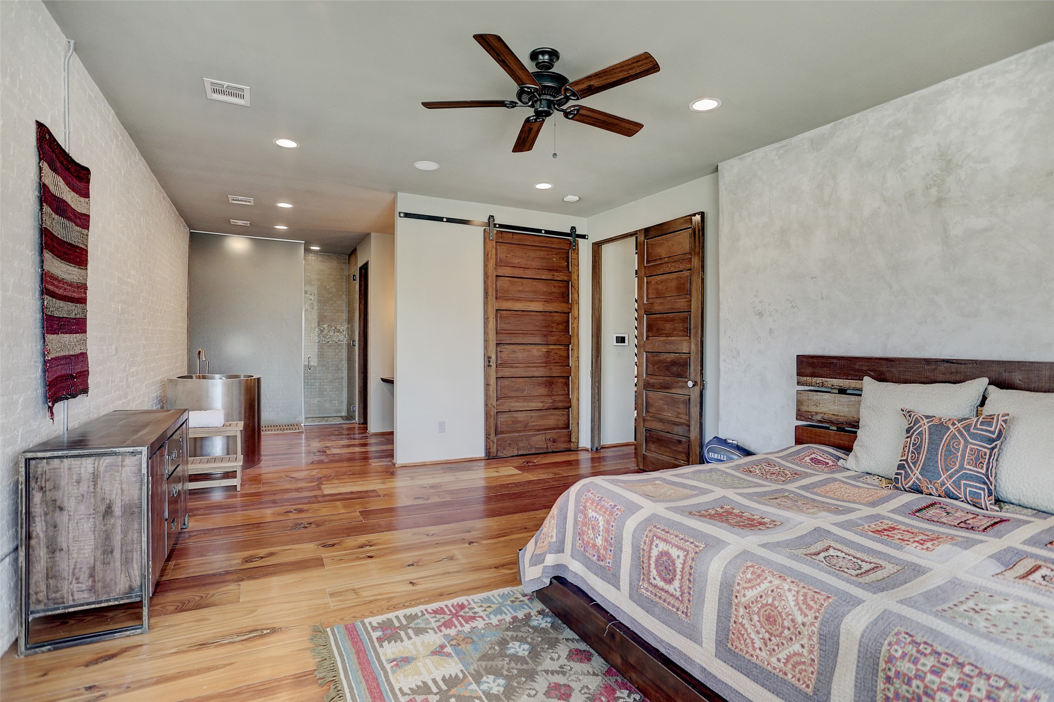 808 Coronado Street Houston, TX 77009 - Photo 20 of 50 Unit 1, Spacious primary bedroom with hardwood floors, ceiling fan, and large windows.