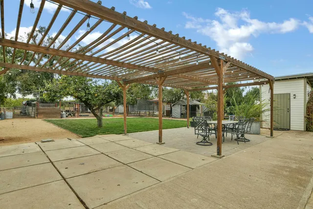 a patio with table and chairs