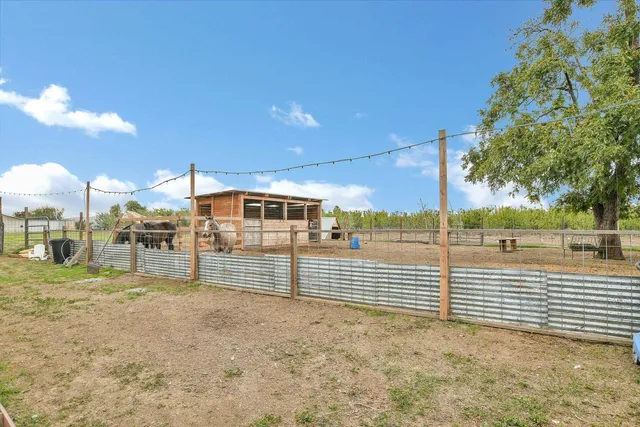 a view of a chairs and table in patio of the house