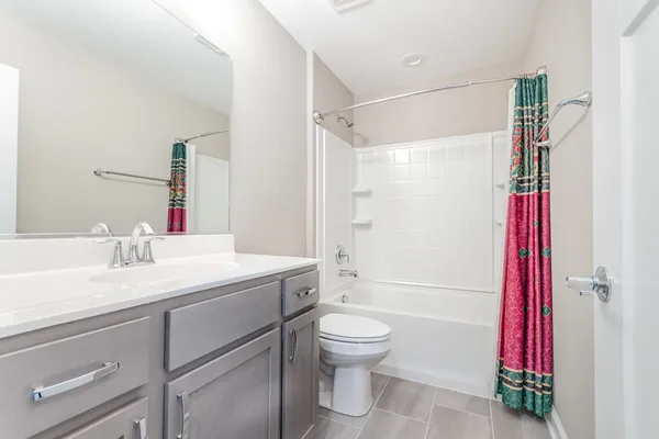 a bathroom with a sink toilet vanity and shower