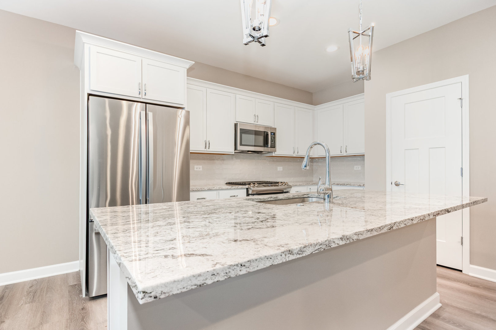 253 Masters Drive Addison, IL 60101 - Photo 3 of 15 a kitchen with stainless steel appliances granite countertop a sink refrigerator and microwave