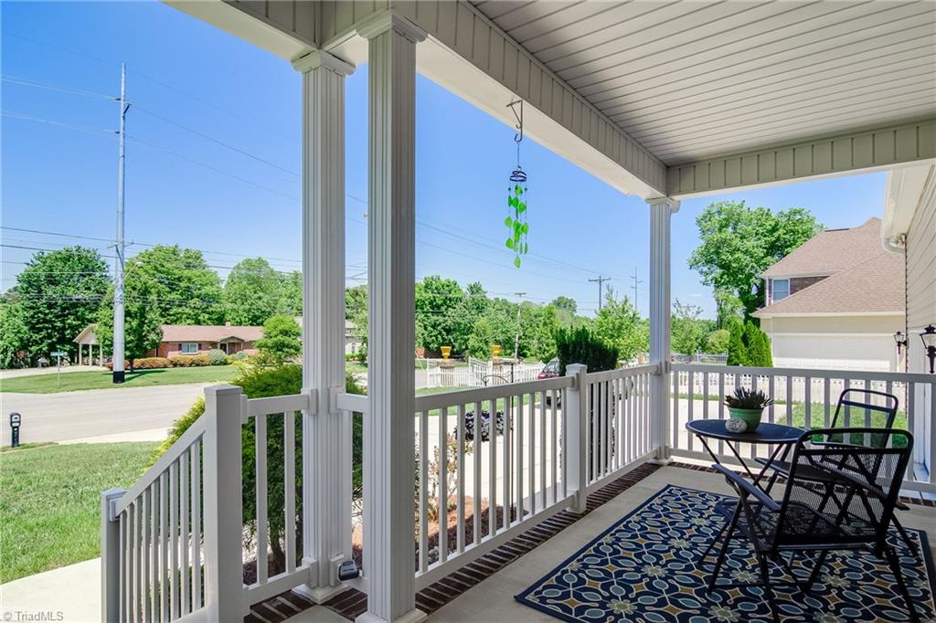 3940 Johnson Street High Point, NC 27265 - Photo 2 of 30 The rocking chair front porch welcomes you to the home. Unwind after your day - this is the perfect spot to watch the setting sun. Spacious enough for rockers or a table and chairs. Note the extended concrete parking pad to the left of the driveway. Great for extra guest and turning around in the driveway.