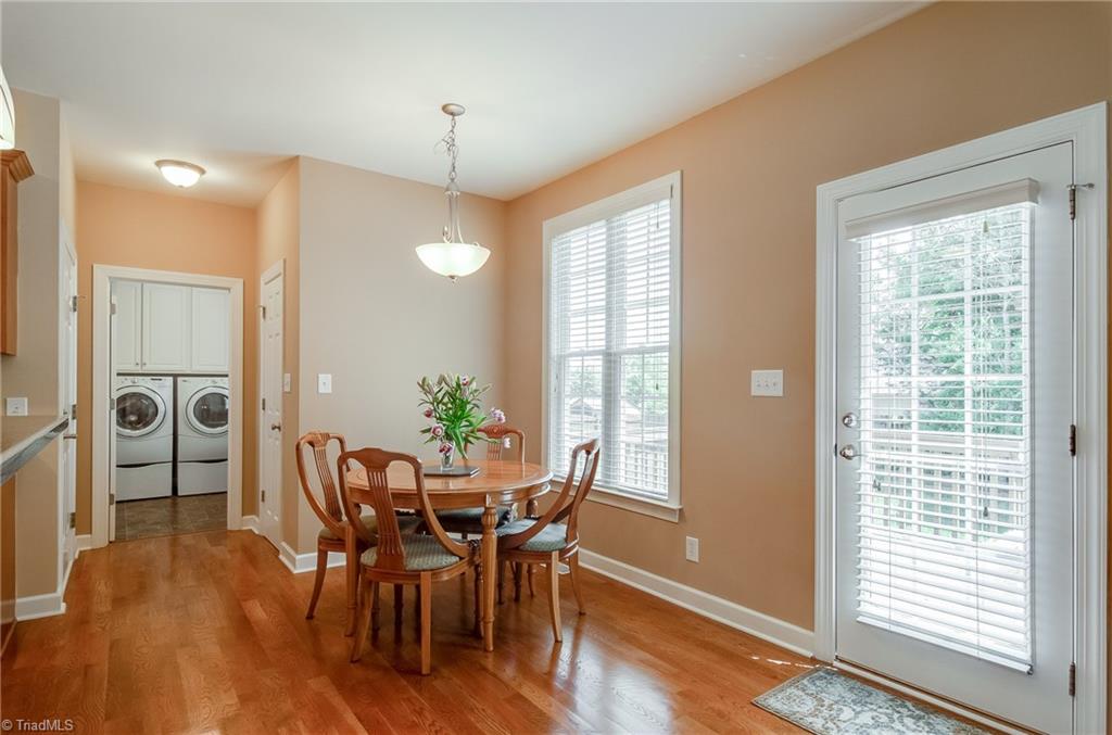 3940 Johnson Street High Point, NC 27265 - Photo 12 of 30 Having space in the eat-in kitchen is perfect for casual dining, homework, or even game night! This area over looks the back yard and door to deck is so convenient.