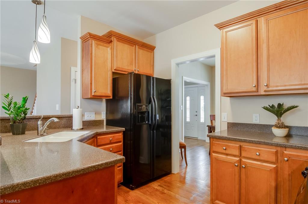 3940 Johnson Street High Point, NC 27265 - Photo 14 of 30 This a beautiful and clean kitchen! The kitchen features Corian countertops, undermount double sink, beautiful lighting above the bar, dishwasher, built-in microwave, and refrigerator (which will remain).