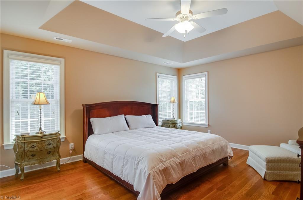 3940 Johnson Street High Point, NC 27265 - Photo 19 of 30 Welcome to the master suite! This spacious room features beautiful hardwood floors, trey ceilings, ceiling fan, large windows and large windows to let the light in.