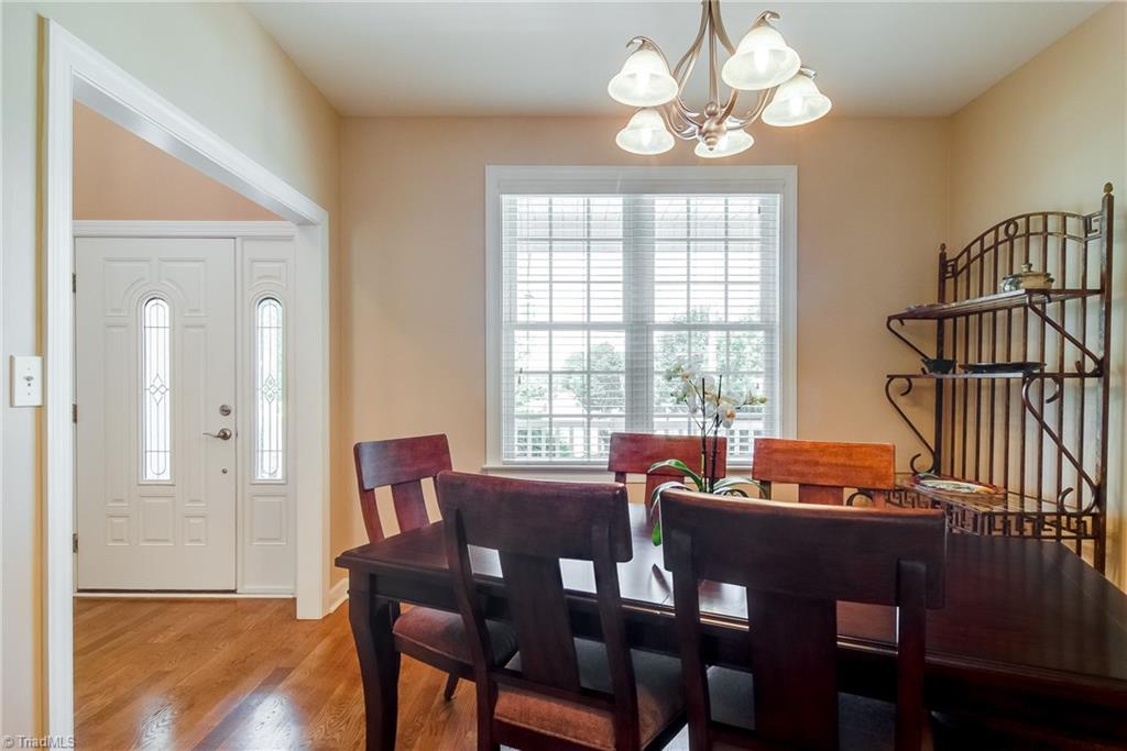 3940 Johnson Street High Point, NC 27265 - Photo 3 of 30 Through the front door, the vaulted entry leads you to the dining room. The large window brings in natural light which bounces off the hardwood floors.