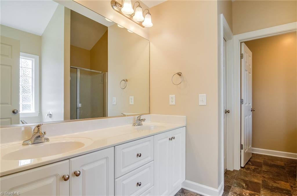 3940 Johnson Street High Point, NC 27265 - Photo 22 of 30 Dual sinks and large vanity with cabinets and drawers makes getting ready in the morning a little easier! Door to the right leads to private water closet. Door to the left leads to large walk in closet!