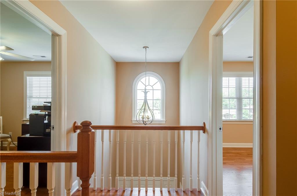 3940 Johnson Street High Point, NC 27265 - Photo 24 of 30 Sitting between bedrooms 2 and 3 is the view of vaulted entry and cat walk in hallway. Seller says the sunset views from this spot are extraordinary!