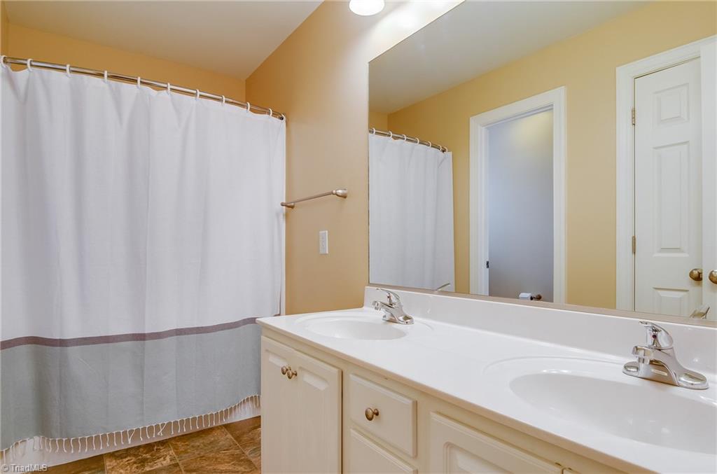 3940 Johnson Street High Point, NC 27265 - Photo 26 of 30 Full bathroom upstairs for second and third bedrooms and bonus room. Bath features closet, private toilet, dual sinks, large vanity, and lots of cabinets and drawers for extra storage.