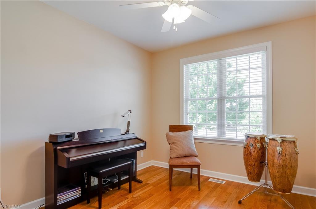 3940 Johnson Street High Point, NC 27265 - Photo 6 of 30 Main level bedrooms are so convenient! With having an adjacent full bath, this is a great option for a guest room, or could alternatively be used as a den, office, play room, or music room. This room features hardwood floors, large window, and ceiling fan.