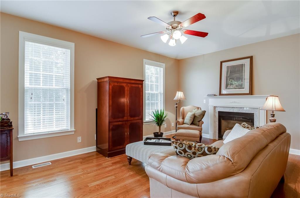 3940 Johnson Street High Point, NC 27265 - Photo 9 of 30 Spacious great room with hardwood floors, large windows letting in natural light, ceiling fan, and gas logs.