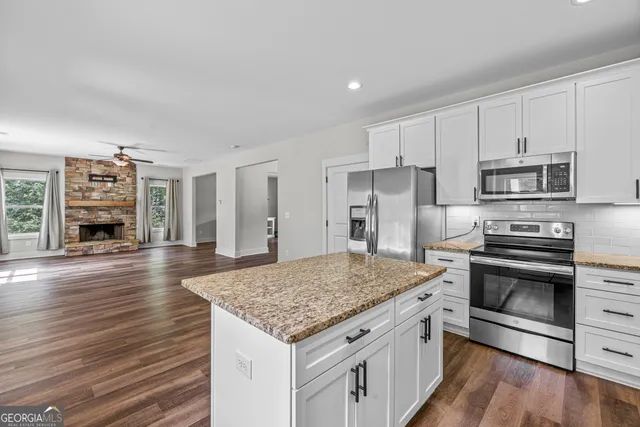 a kitchen with stainless steel appliances granite countertop a stove and a sink