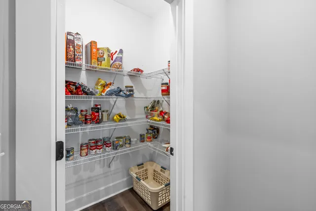 a bathroom with a granite countertop sink toilet and mirror