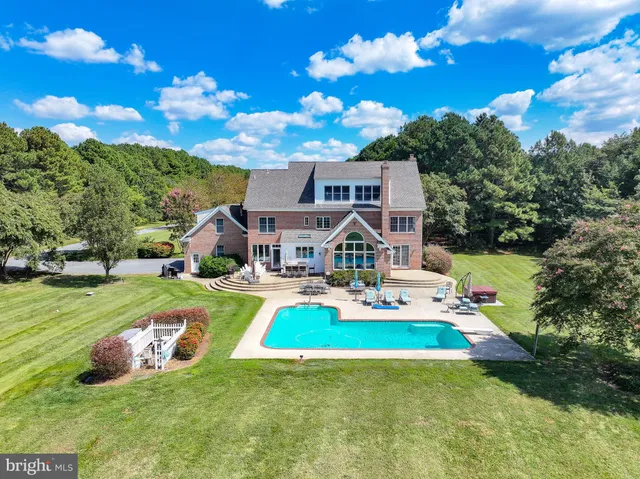 a aerial view of a house with swimming pool garden and patio
