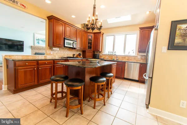 a view of a livingroom with a fireplace wooden floor and windows