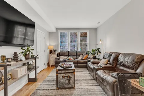a living room with furniture fireplace and a window