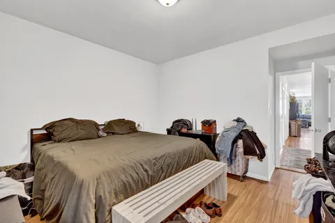 a bedroom with two beds and painting on the wall