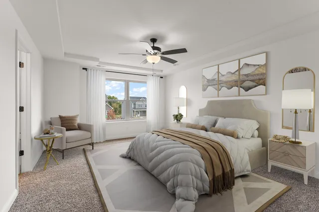 a bedroom with a bed couch and window