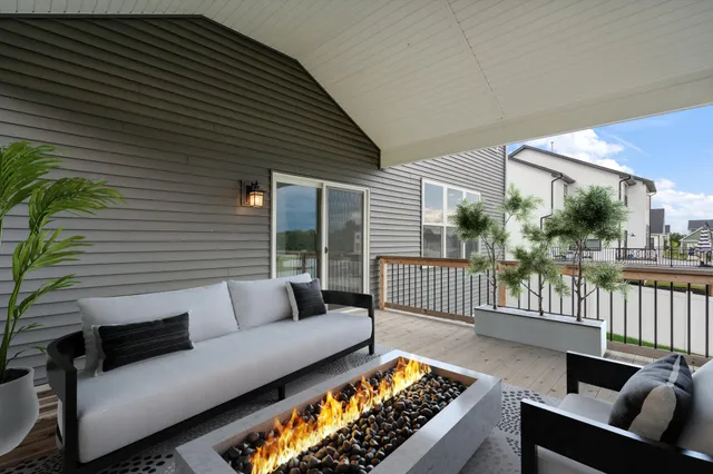a balcony with furniture and a potted plant